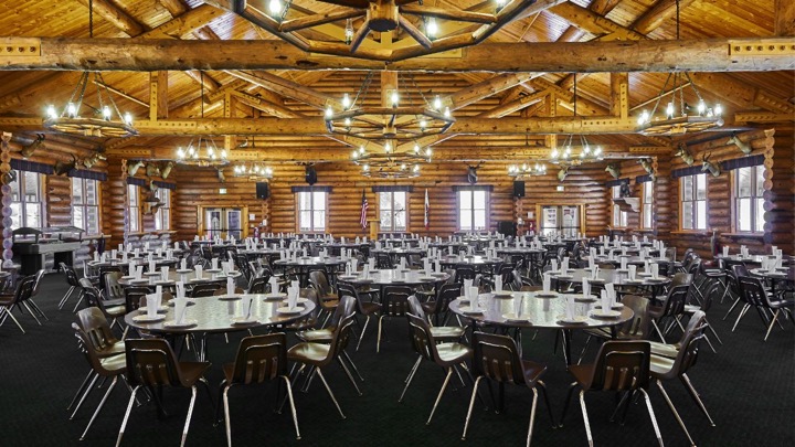 Tables set in the camp dining hall.