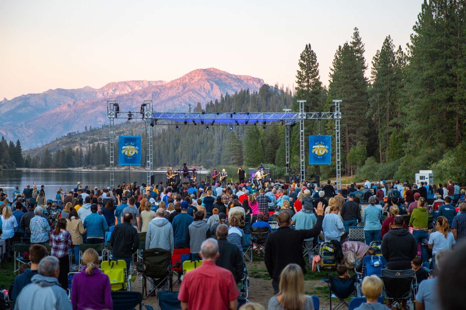 Evening worship at Hume, the crowd gathered with the mountains behind them.